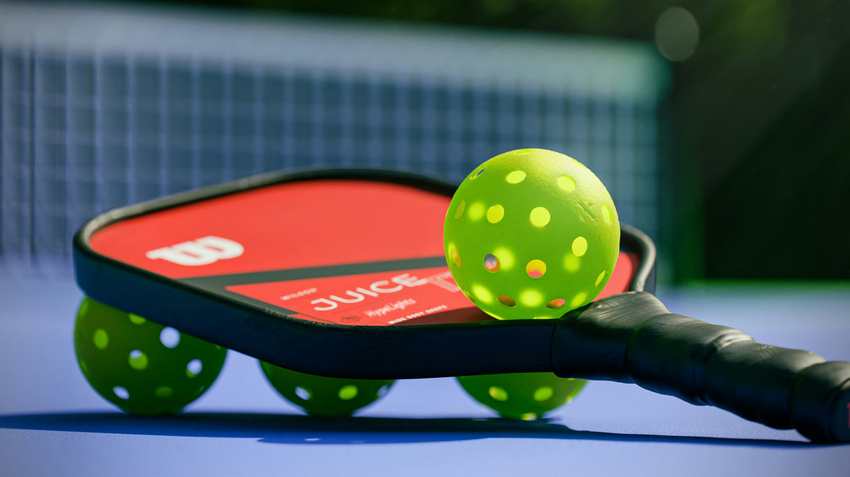 Pickleball paddle and balls ready on the court