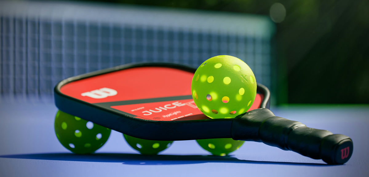 Pickleball paddle and balls ready on the court