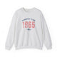 Ash pickleball crewneck sweatshirt with a distressed collegiate-style "Bainbridge Island 1965 WA" text stack in navy and coral