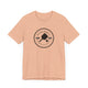 Heather Peach pickleball t-shirt with a circular Pickleball Bainbridge Island badge logo