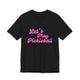 Black pickleball t-shirt with a pink script Let's Play Pickleball text design