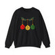 Black crewneck sweatshirt with pickleballs styled as Christmas ornaments hanging from a holly branch