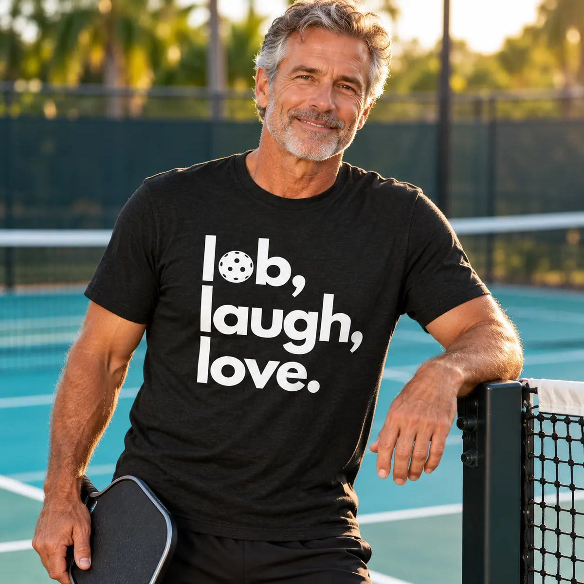 Man wearing a black heather lob, laugh, love pickleball T-shirt.