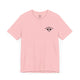 Pink t-shirt with a small black PICKLEBALLER chest logo featuring crossed paddles