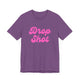 Heather team purple pickleball t-shirt with a pink script Drop Shot text design