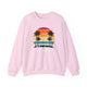 Light Pink pickleball crewneck sweatshirt with a retro sunset circle with silhouetted palm trees and "West Coast Pickleball" script text