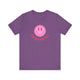 Heather Team Purple pickleball t-shirt with a pink smiley face graphic over "Pickleball" text
