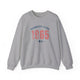 Sport Grey pickleball crewneck sweatshirt with a distressed collegiate-style "Bainbridge Island 1965 WA" text stack in navy and coral