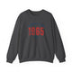 Dark Heather pickleball crewneck sweatshirt with a distressed collegiate-style "Bainbridge Island 1965 WA" text stack in navy and coral