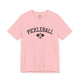 Pink t-shirt with an arched PICKLEBALL text design over crossed paddles