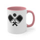White mug with a Pink accent and a minimalist icon of two crossed pickleball paddles and a ball
