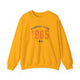 Gold pickleball crewneck sweatshirt with a distressed collegiate-style "Bainbridge Island 1965 WA" text stack in navy and coral