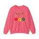 Safety pink crewneck sweatshirt with pickleballs styled as Christmas ornaments hanging from a holly branch