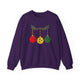 Purple crewneck sweatshirt with pickleballs styled as Christmas ornaments hanging from a holly branch