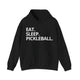 Black hoodie with Eat. Sleep. Pickleball. text design