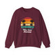 Maroon pickleball crewneck sweatshirt with a retro sunset circle with silhouetted palm trees and "West Coast Pickleball" script text