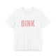White pickleball t-shirt with a bold, distressed red "DINK" wordmark