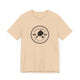 Heather Sand Dune pickleball t-shirt with a circular Pickleball Bainbridge Island badge logo