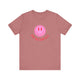 Pickleball t-shirt with a pink smiley face graphic over "Pickleball" text