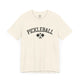 Natural t-shirt with an arched PICKLEBALL text design over crossed paddles