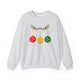 Ash crewneck sweatshirt with pickleballs styled as Christmas ornaments hanging from a holly branch