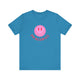 Aqua pickleball t-shirt with a pink smiley face graphic over "Pickleball" text