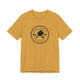 Heather Mustard pickleball t-shirt with a circular Pickleball Bainbridge Island badge logo